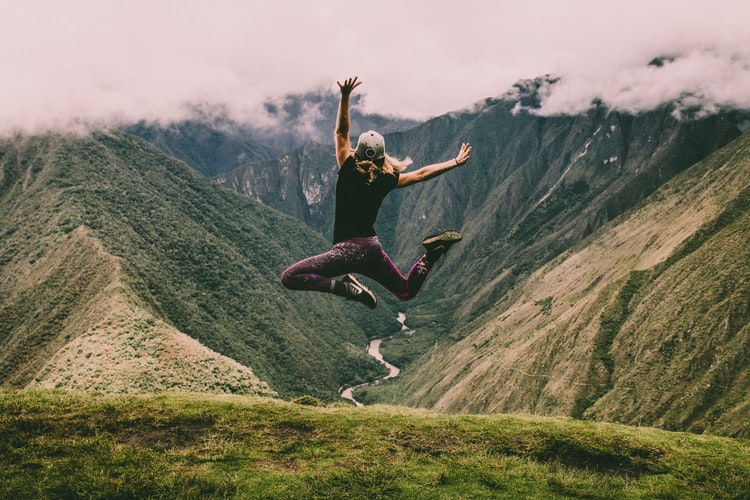 woman jumping in mountains