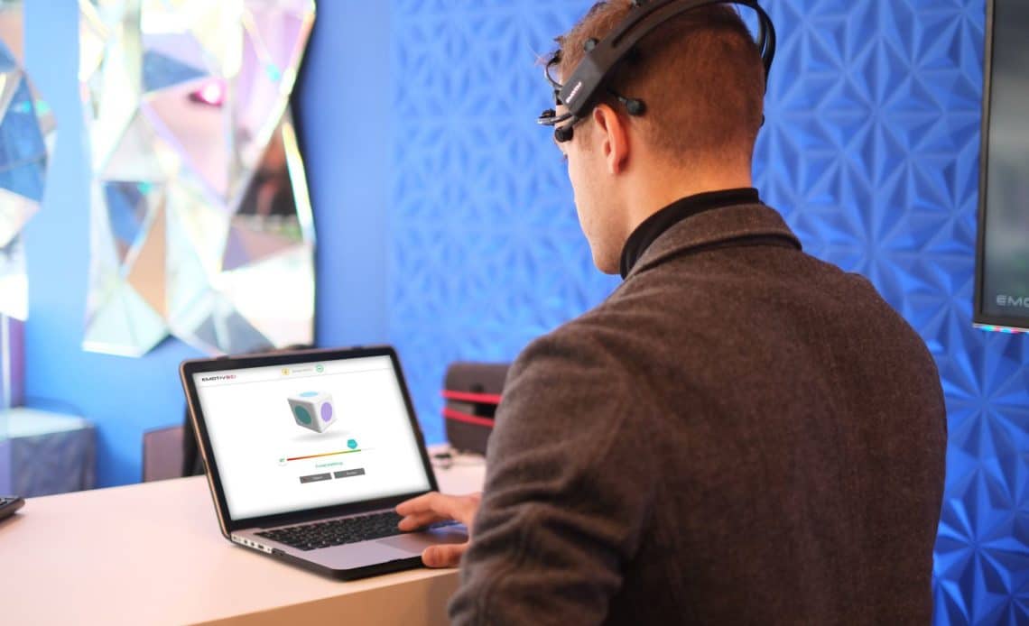 Young man using Emotiv headset to track cognitive performance