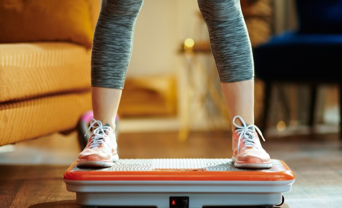 woman standing on vibration plate