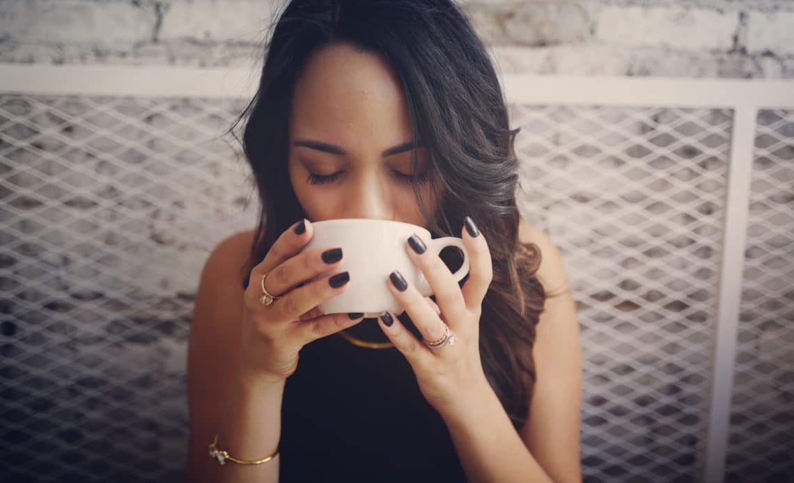 woman sipping on mug
