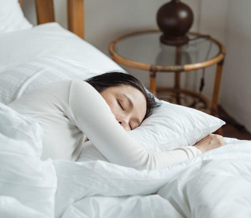 Young woman sleeping in comfy bed
